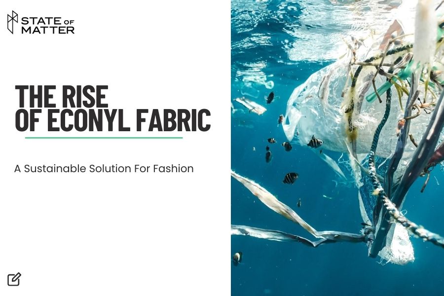 Featured image for blog post: "THE RISE OF ECONYL FABRIC" by State of Matter, showing an underwater scene with fish and floating fabric, emphasizing sustainable fashion.
