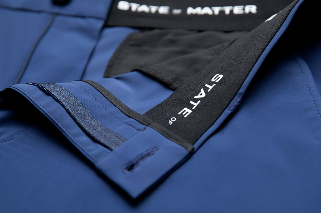 A close up of the zipper on a pair of State of Matter sustainable men's navy blue chino pants 