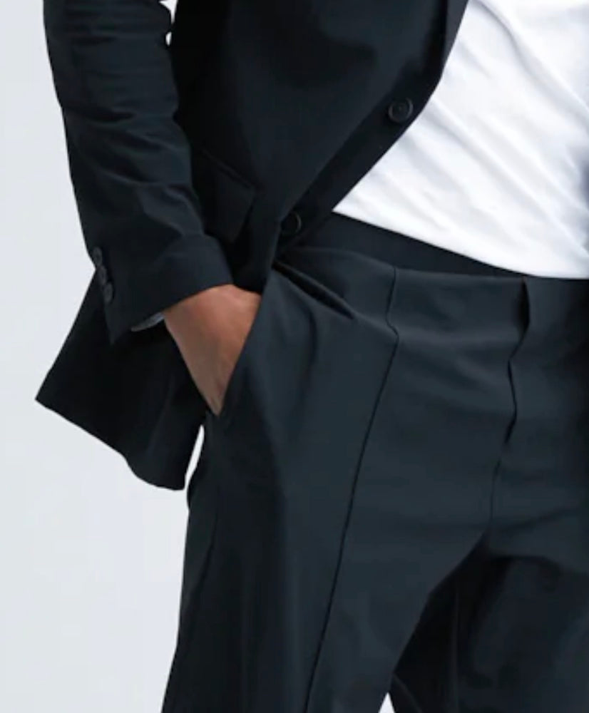 State of Matter sustainable black suit close up on hand in pant pocket and men's white Henley top 
