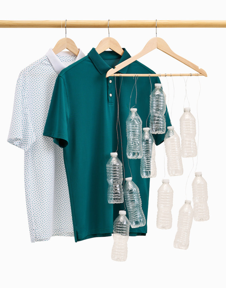 Image of State of Matter men's polo shirts hung up on hangers next to recycled water bottles 