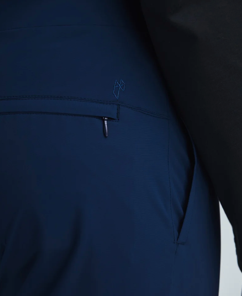 Close-up on the back pocket of a pair State of Matter navy suit pants. 
