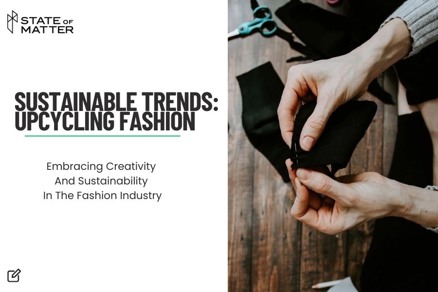 Featured image for blog post: "SUSTAINABLE TRENDS: UPCYCLING FASHION" by State of Matter, showing hands stitching black fabric with tailoring tools in the background.