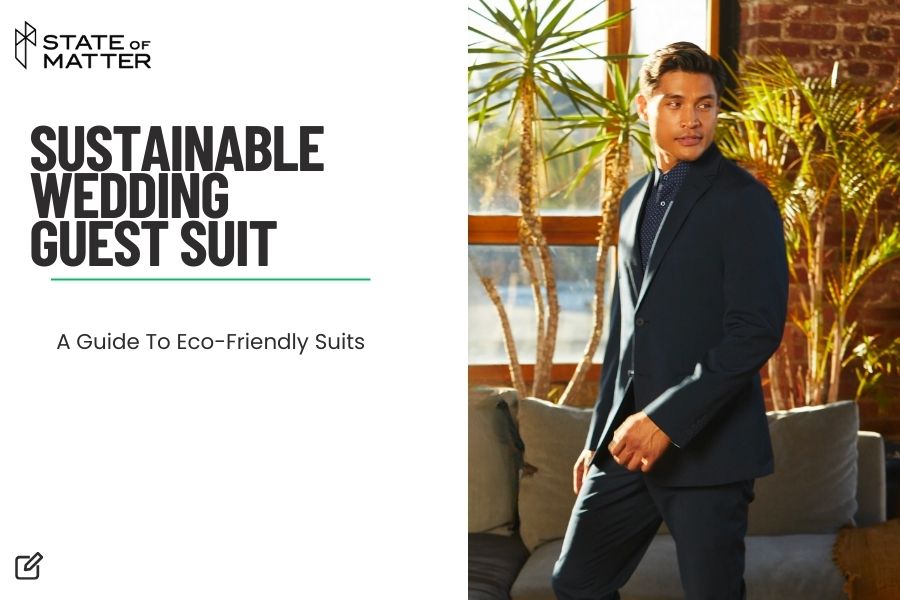 Featured image for blog post: "SUSTAINABLE WEDDING GUEST SUIT - A Guide To Eco-Friendly Suits" by State of Matter, showing a man in a dark, tailored suit poised in a sunlit room with large windows and green plants, embodying sustainable fashion elegance.