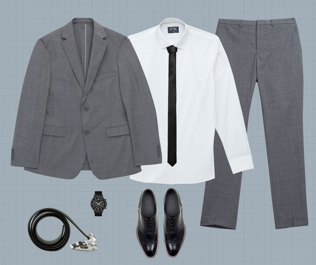 Image of a roller up belt, a watch, dress shoes, a white button down with a black tie, and a State of matter grey suit against a light grey backdrop. 