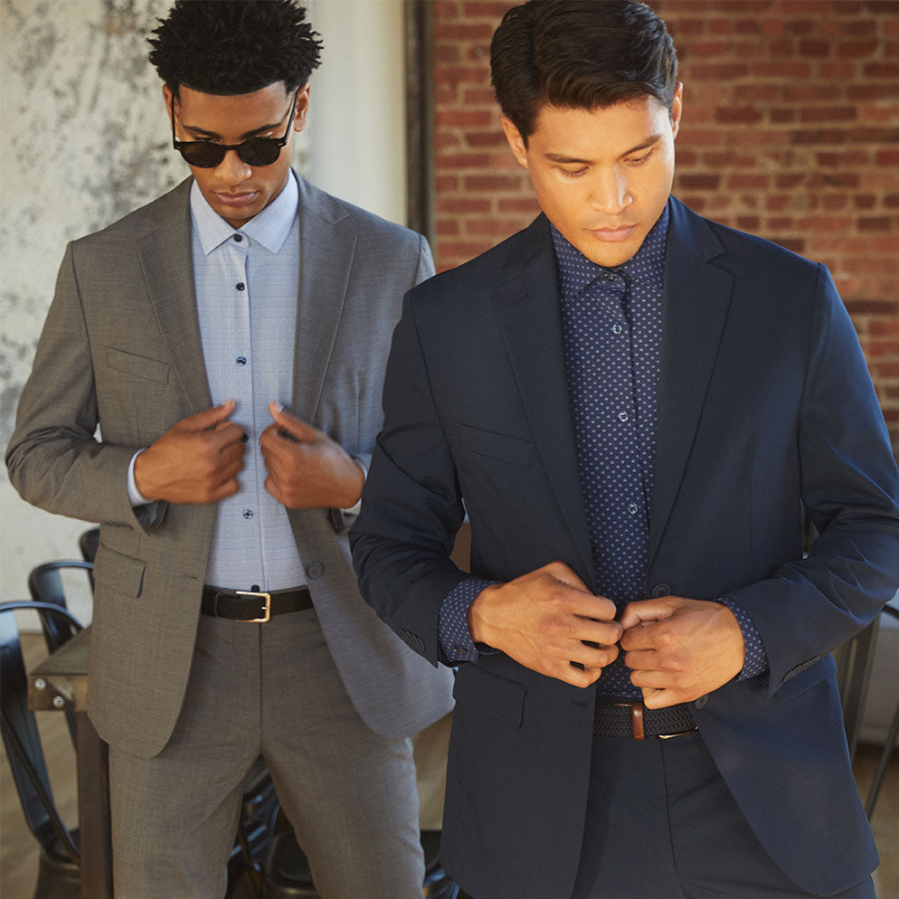 Image of two men standing side-by-side pulling on their State of Matter men's suit jackets 