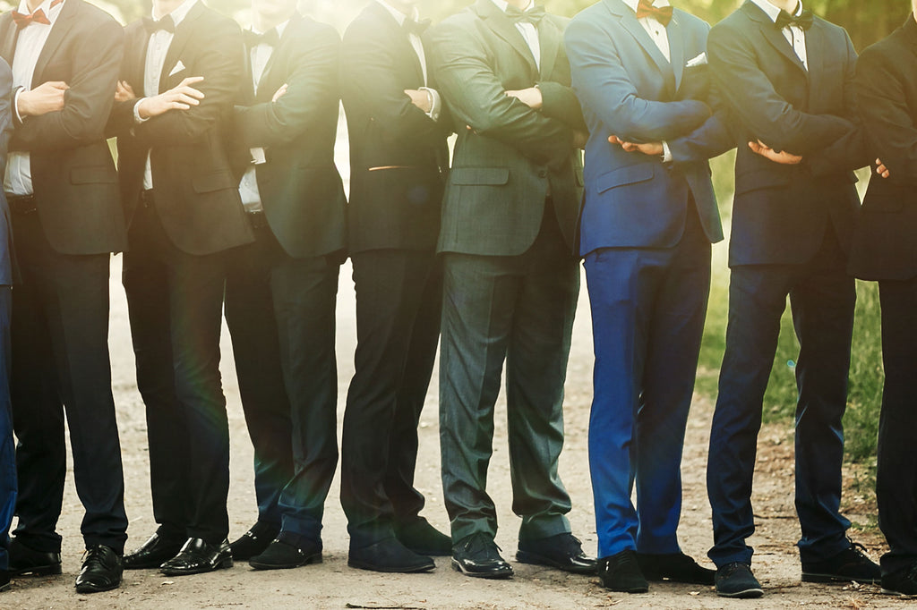 A wedding party group photo in which al the men have their arms crossed and are wearing State of Matter Cooling Performance Suits. 