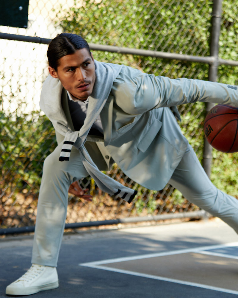 A man playing basketball in a grey State of Matter suit 