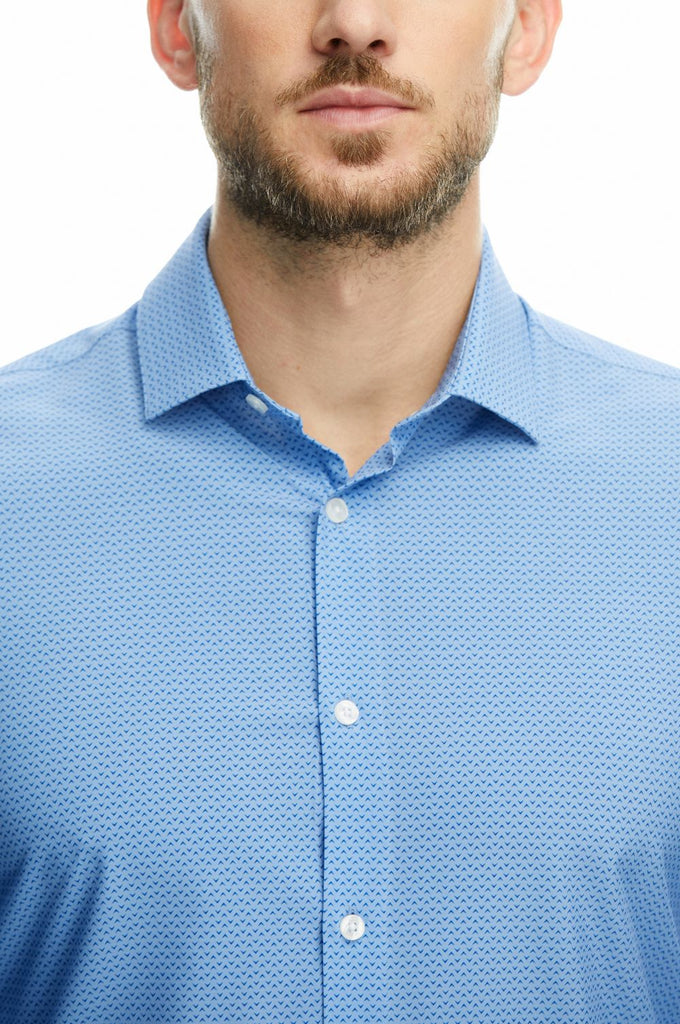 Up close picture of man wearing a long sleeve blue button down shirt by state of matter