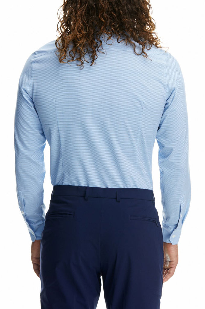 A back shot of a man wearing a long sleeve lulu Geo print dress shirt