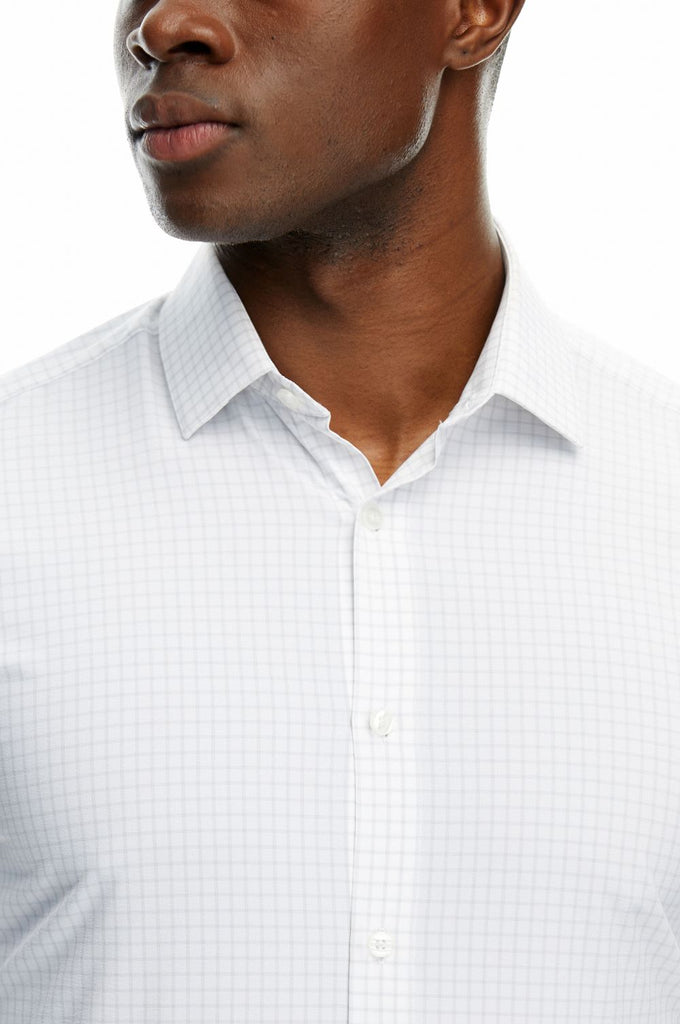 Close-up shot of a man wearing State of matter sustainable long sleeve grey checkered button down shirt