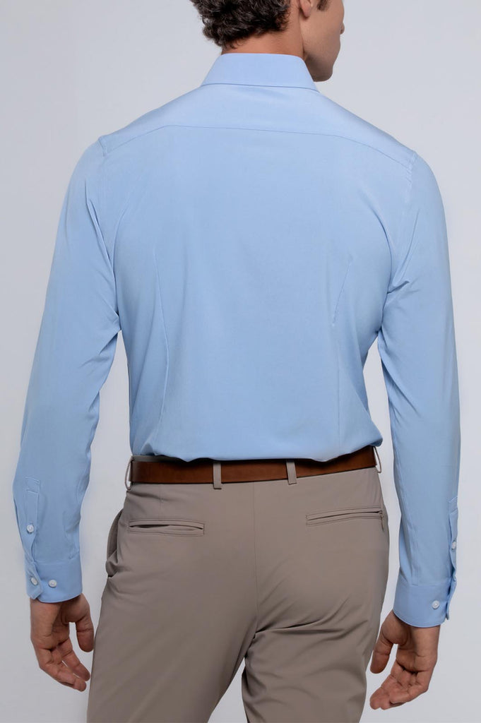 Back view of a man wearing state of matter sustainable men's long sleeve light blue shirt and khaki chino pants